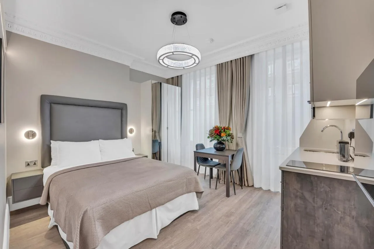 Studio apartment with bed and dining table at Cleveland Residences Bloomsbury