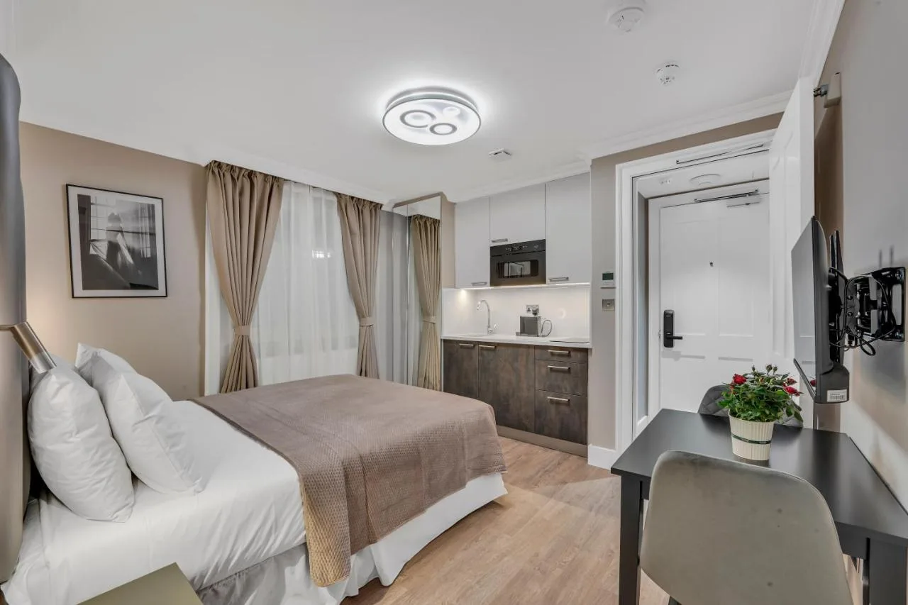 Bedroom with desk and kitchenette in a Bloomsbury studio apartment
